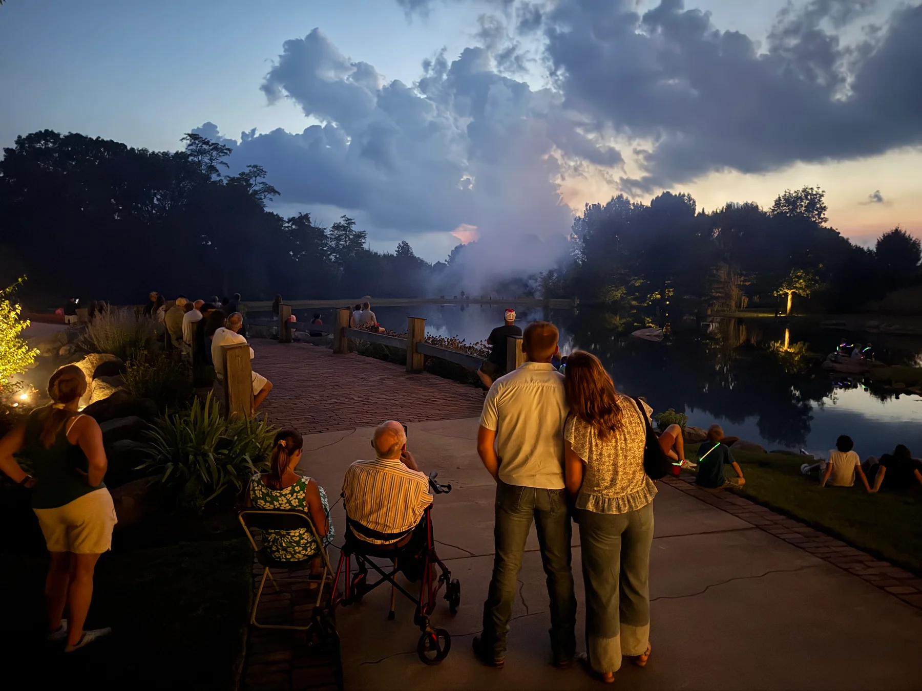 Families gathered along the pond during the fish fry evening