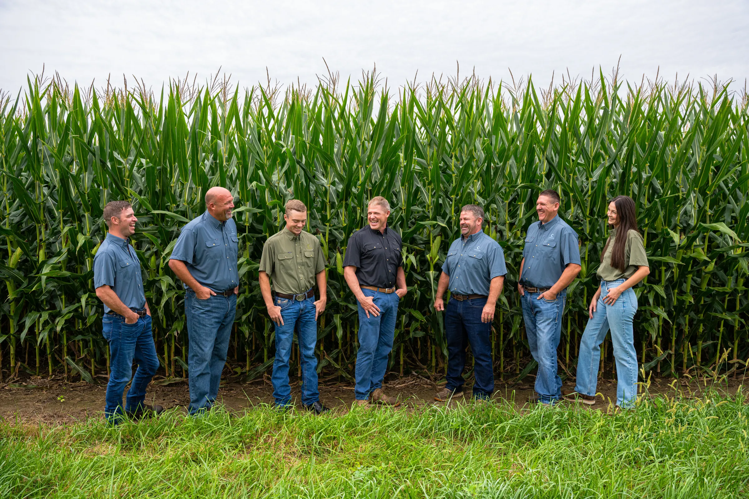Indiana Specialty Group members sharing a laugh beside a corn field